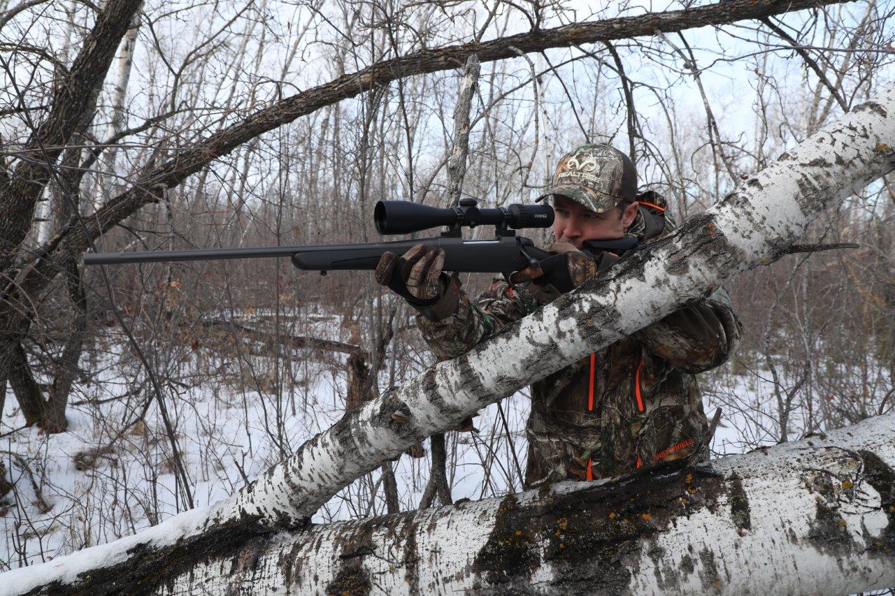 Sako, hunter taking a shot with a rifle