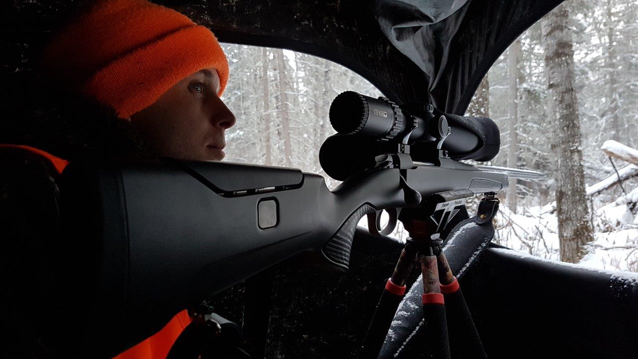 Sako, hunter with a rifle on a tripod